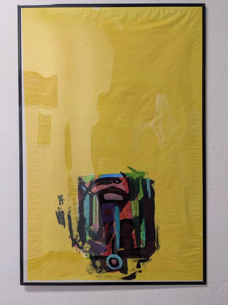 A tall field of yellow fills almost the whole frame, bright and unbroken from top to bottom. Down near the lower edge